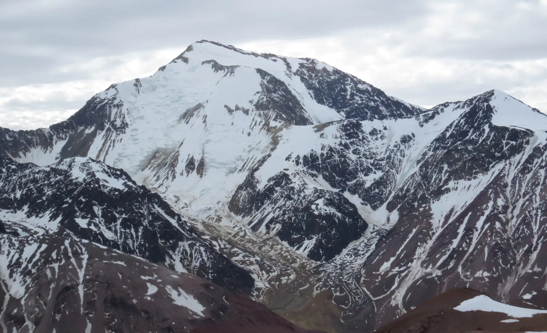 Snow-covered Cerro Mercedario above rugged ridges in the high Andes of Argentina