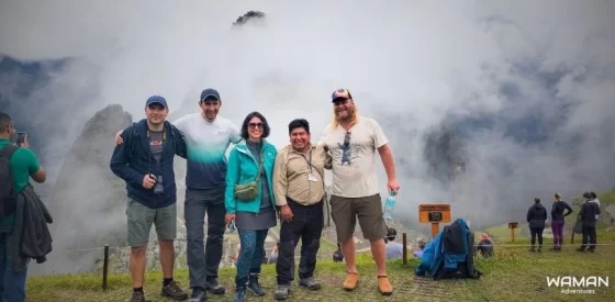 Viajeros de Waman Adventures en Machupicchu con neblina, temporada de lluvias