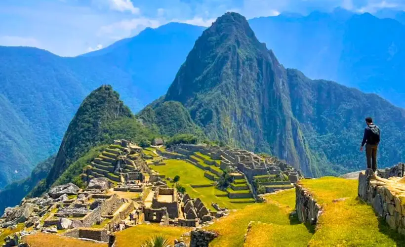Tourist gazes at the full splendor of the Machu Picchu archaeological site.