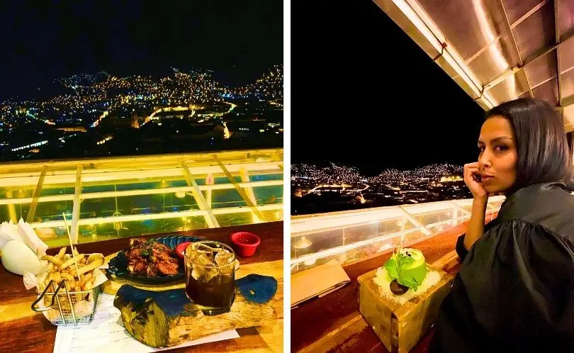 Tourist enjoys panoramic nighttime view of Cusco from an overlook.