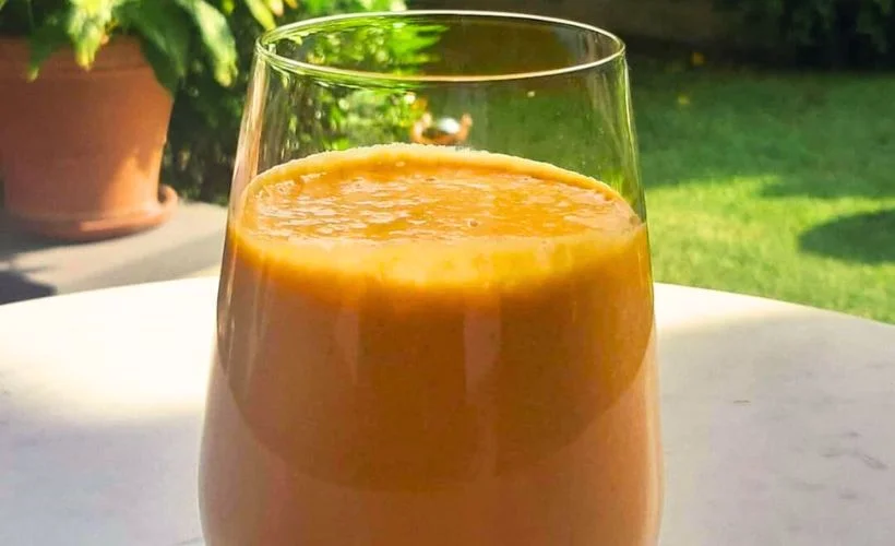 Glass of creamy orange lucuma juice made from Peruvian lucuma fruit