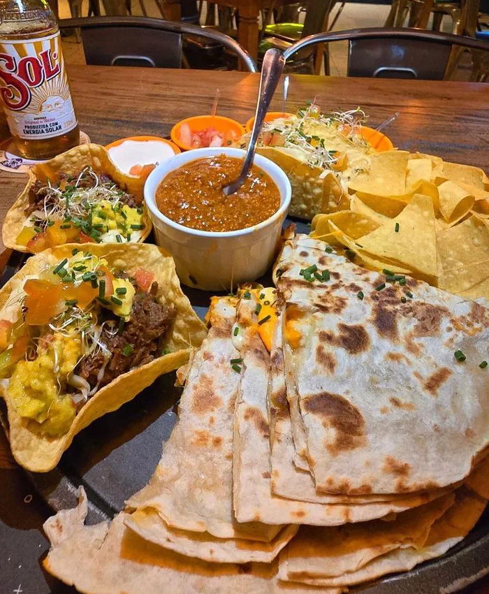 Las quesadillas están doradas y rellenas de queso derretido, cortadas en triángulos listos para compartir.