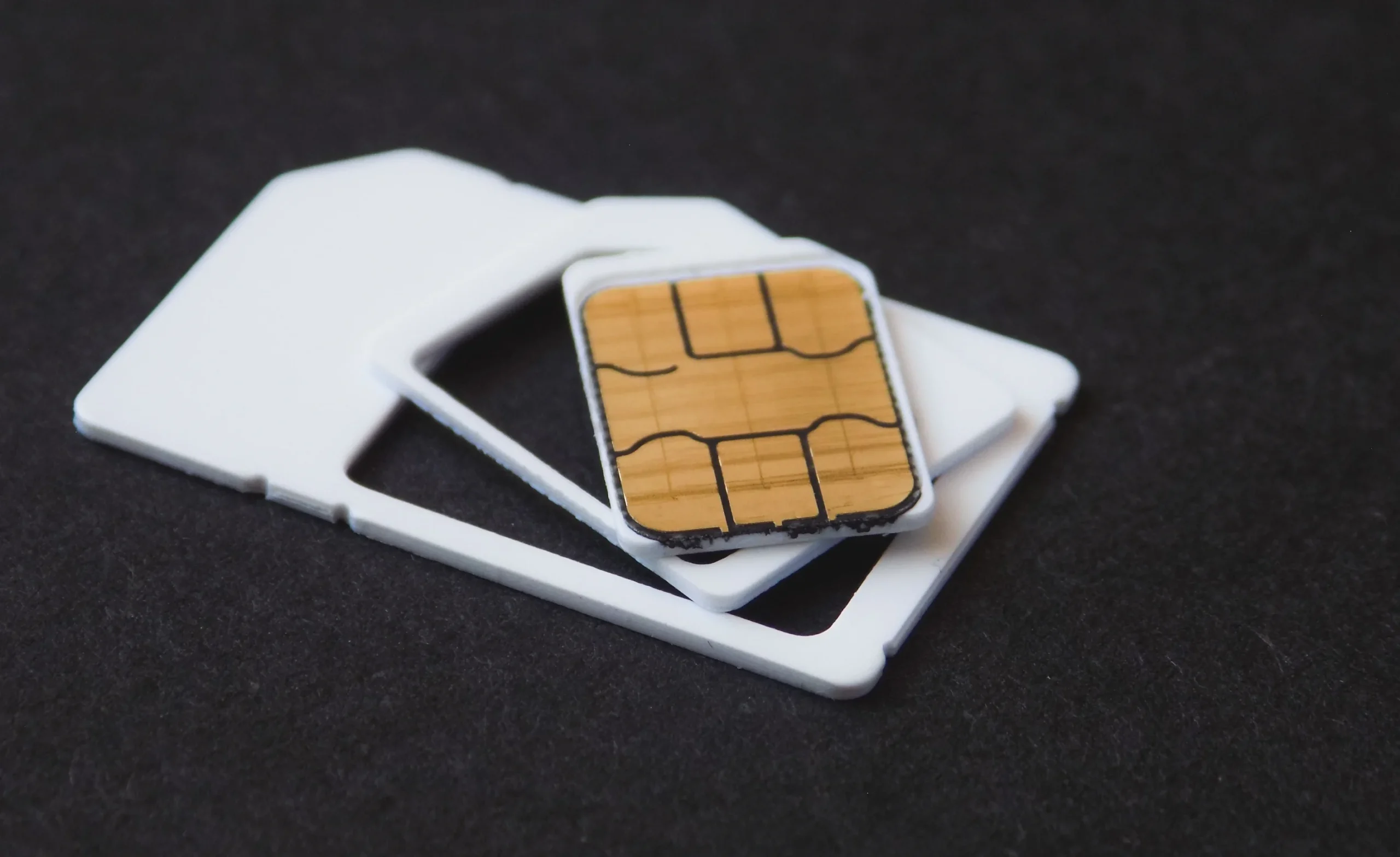 SIM card placed on plastic adapters, used to activate mobile service and internet connectivity while traveling abroad.