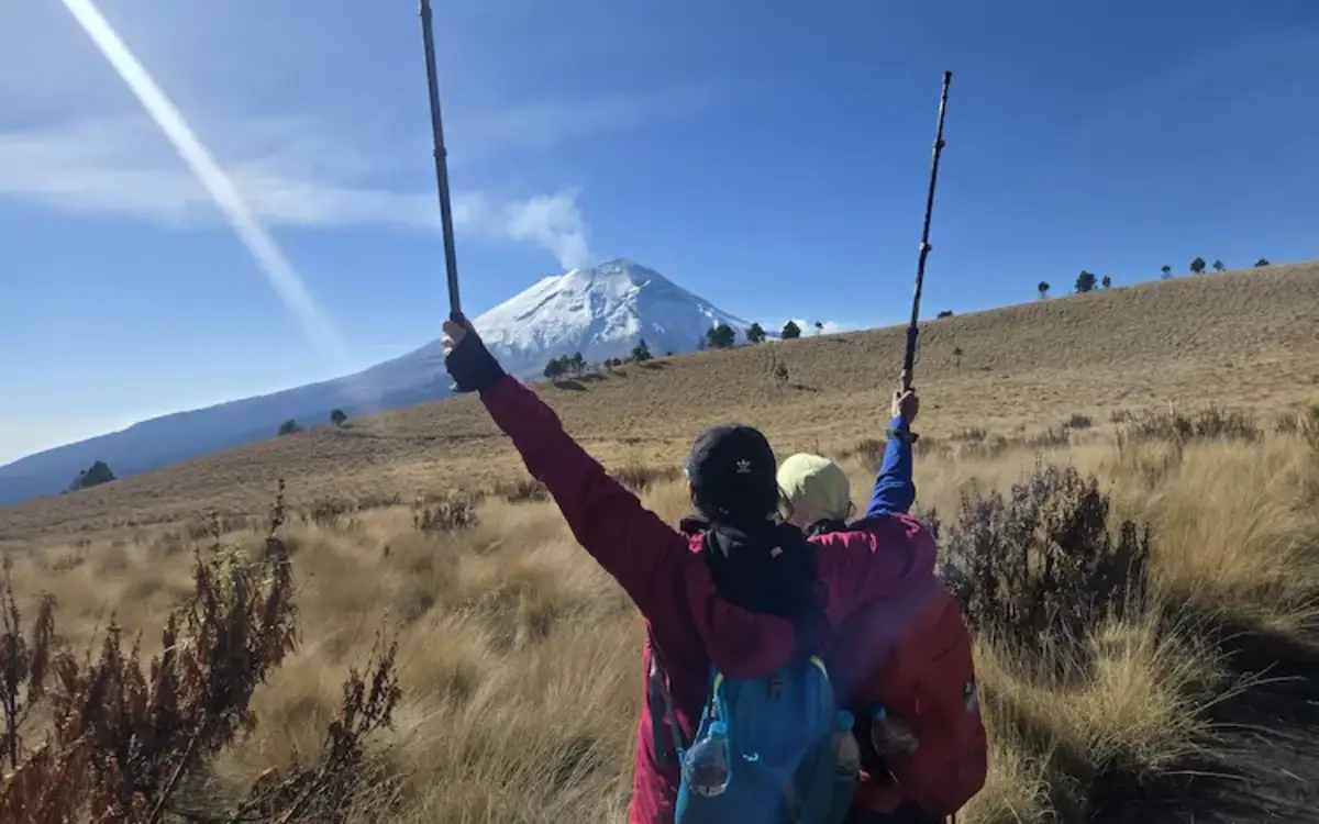 Excursionistas con bastones y equipo de trekking caminando por los pastizales del Iztaccíhuatl