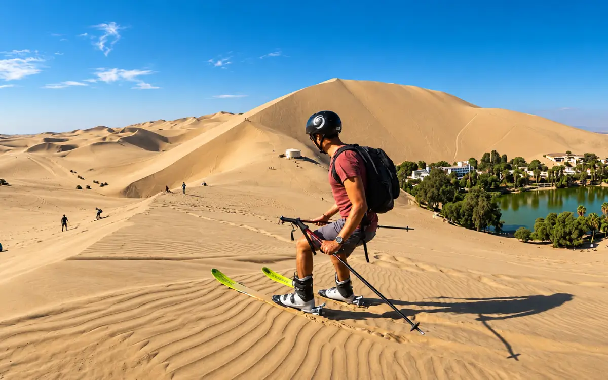 Viajero descendiendo una duna de Huacachina con equipo para deportes sobre arena
